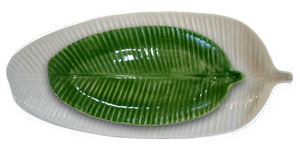 Paired colour options of the small banana leaf plate and large banana leaf platter, in glazes green and white