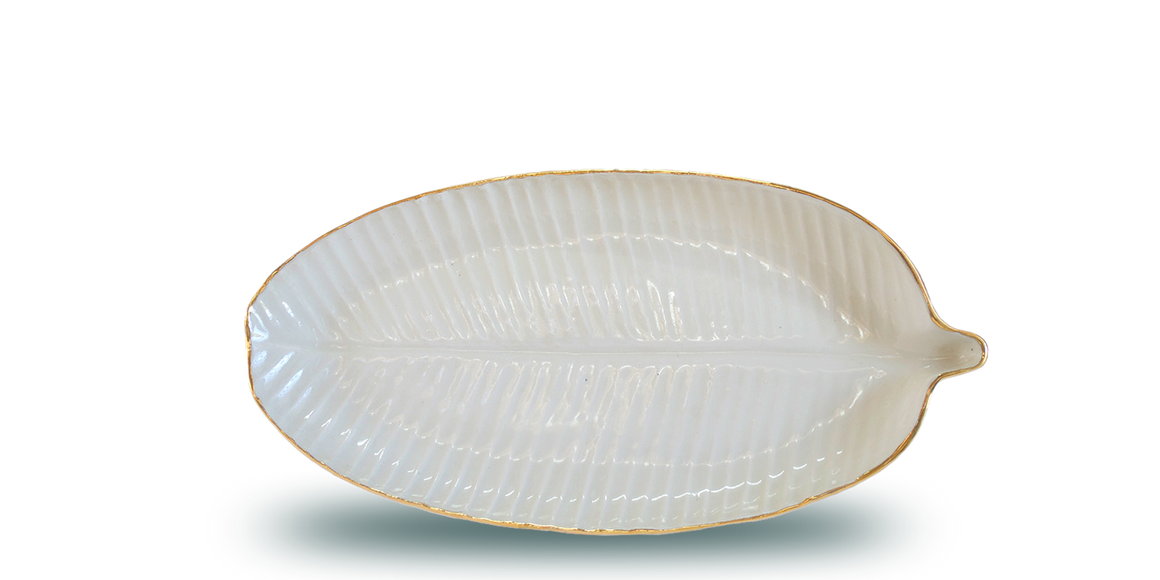 Handmade ceramic plate in the shape of a banana leaf, in a clear glaze, white colour, and an 18 karat gold rim around the edge. Great texture, feels good to the touch