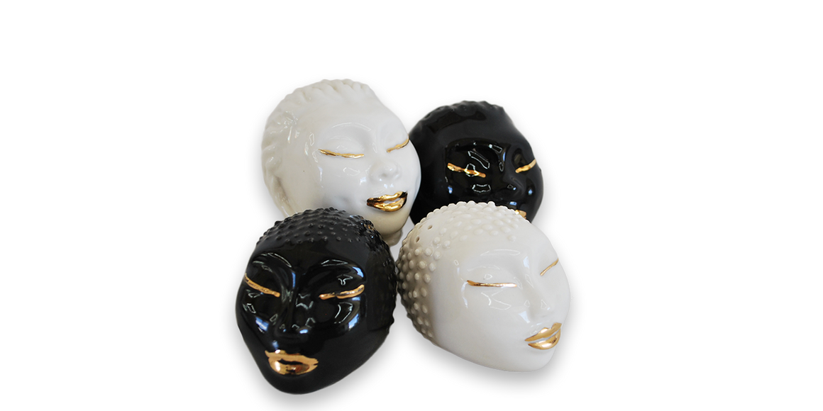 Handmade salt and pepper shakers in white and black with 18 karat gold lips and eyelashes 